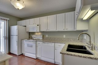 Bright kitchen with newer granite countertops and composite granite sink