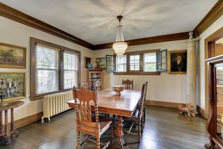 The Formal Dining Room features Original Piano Style Windows, Crown Moldings & Hardwood Floors! 