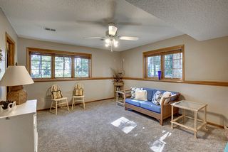 Family/Game room with ceiling fan and daylight windows.