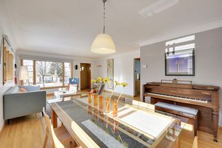 The Light-Filled Living & Dining Room features Hardwood Floors and Coved Ceilings...