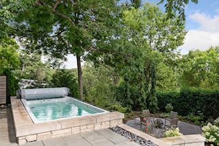 Resistance pool and jacuzzi spa overlooking the lower deck with firepit