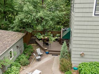 Another lower level deck off the back of the home between three car garage and back entry