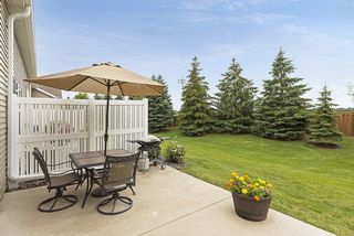 Partially fenced yard and cement slab patio. 