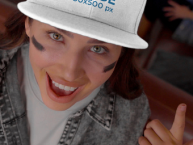 Video of a Woman Pointing at Her Snapback Hat While Enjoying the Big Game 4509v