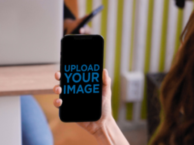 Video of a Woman Holding an iPhone 12 Pro Max at an Office 4752v