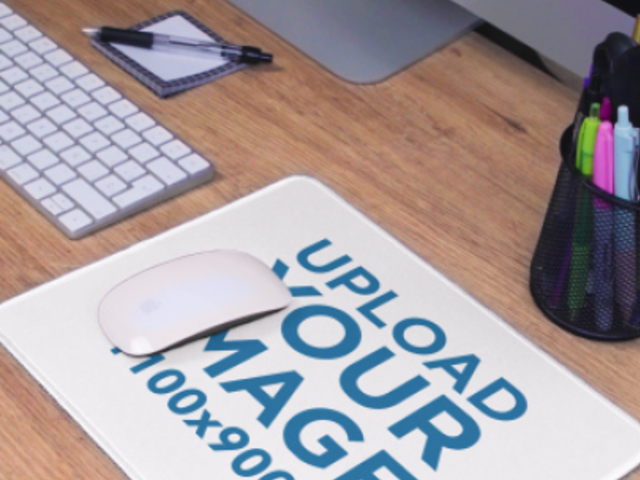 Video of a Mousepad Placed over a Wooden Desk Near an iMac 4934v