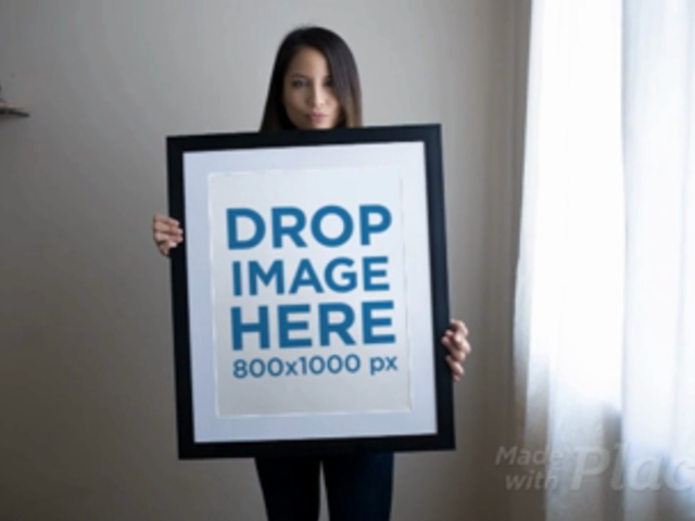 Beautiful Girl Holding a Big Framed Art Print Video While Doing Faces a14358