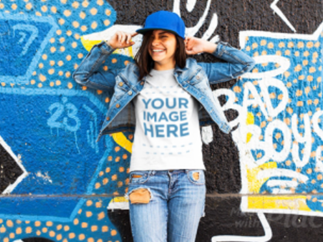 Young Trendy Girl Wearing a Hat and  a Tshirt Stop Motion with Denim Jacket Near a Graffiti Wall a13365
