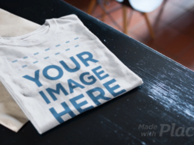 Folded T-Shirt Video Lying on a Dark Wooden Table a13132