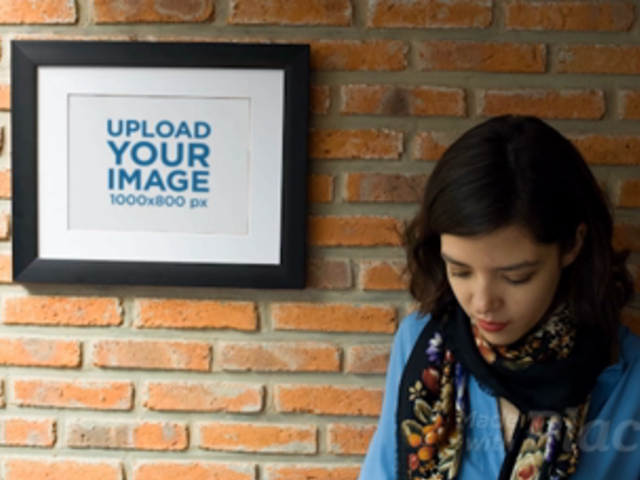 Girl Texting on her Phone While Against a Bricks Wall With a Framed Art Print Video a14355