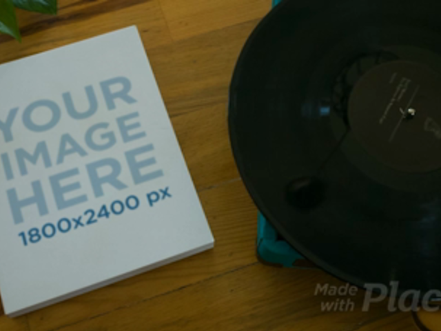 Video of a Book Lying Alongside a Turntable with a Vinyl on It Mockup a14013b