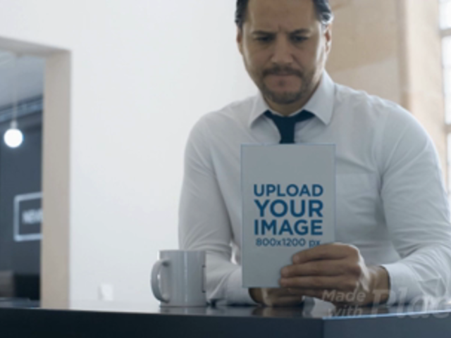 Business Man Having a Coffee While Taking a Look at a Book Video Mockup a14152