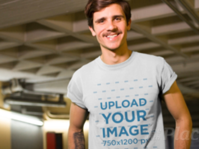 Hipster Guy with Tattoos and a Mustache Walking Through a City Tunnel Wearing a T-Shirt Video a13466