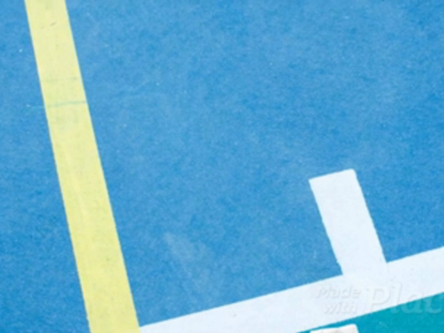 Volleyball Jersey Maker - Folded Jersey Lying on a Court Near a Volleyball a16929