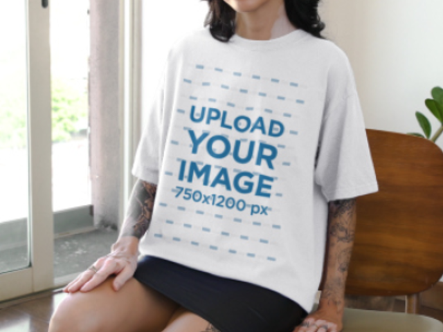 Video of a Tattooed Woman Wearing a Round-Neck Tee While Sitting on a Chair 6593v