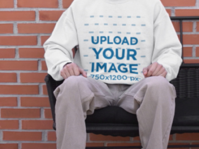 T-Shirt and Sweatshirt Video Featuring a Happy Man Sitting on a Bench While Making a TikTok 6686v