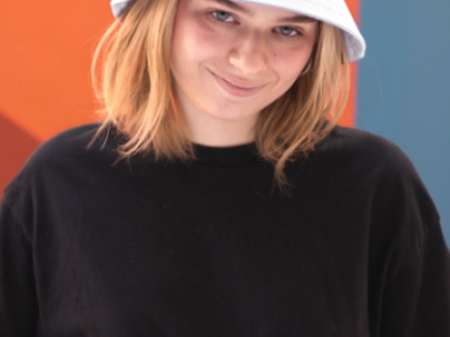 Bucket Hat Video Featuring a Smiling Woman Posing for a TikTok 6676v