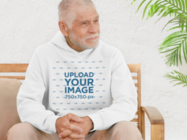 Gildan Hoodie Video Featuring a Calm Senior Man Sitting on a Wooden Chair 8748v