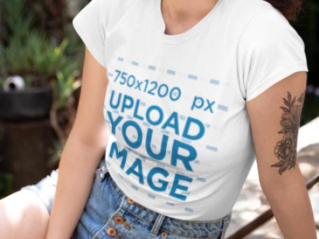 T-Shirt Video of a Young Tattooed Woman Sitting on a Wooden Garden Table 22438