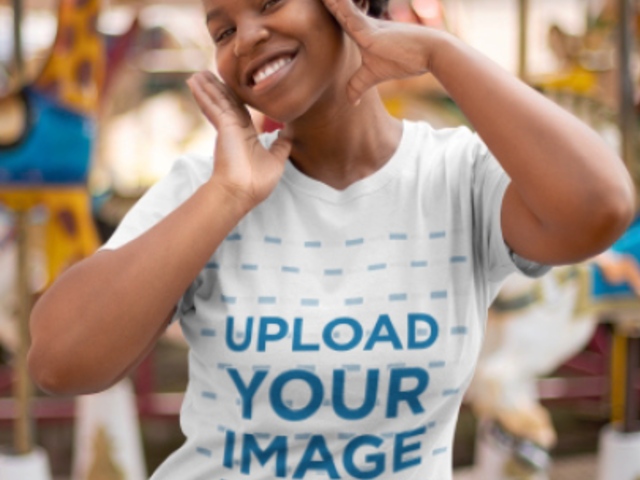 T-Shirt Video Featuring a Joyful Woman Posing by a Carousel 22991