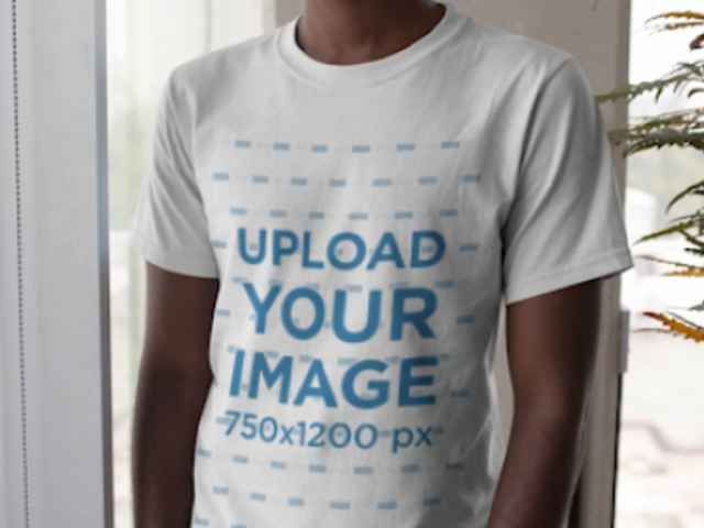 T-Shirt Video Featuring a Young Man With Dyed Hair Standing by a Window 22540