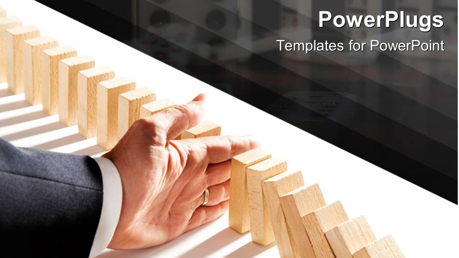 Adult Hand Falling a Row of Arranged Domino Tabs