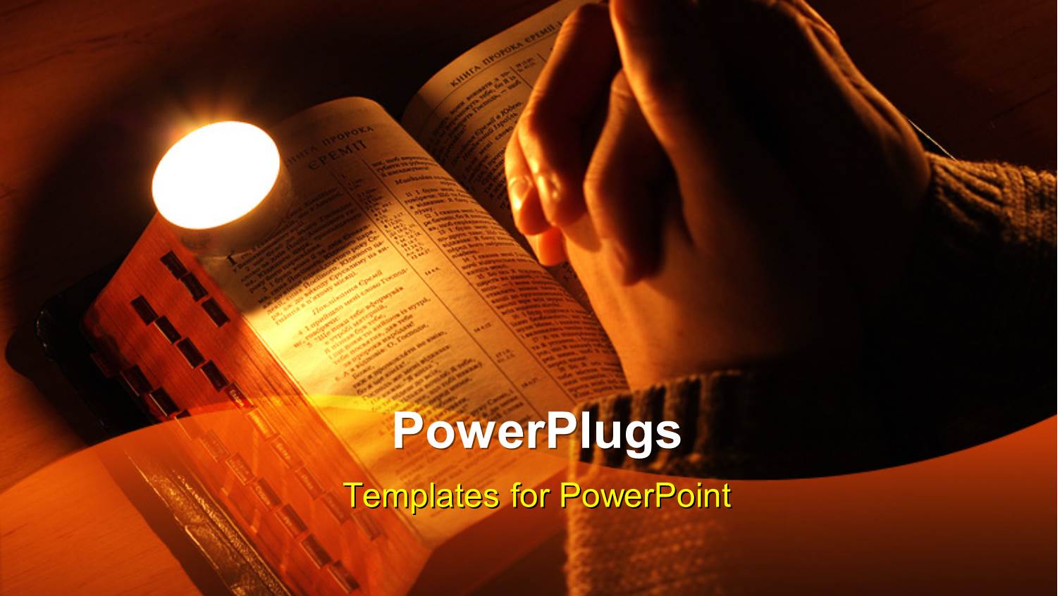 Arms Crossed in Prayer on the Bible with the Candle