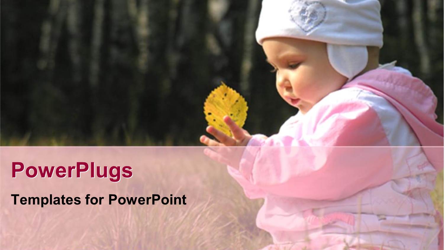 Baby Girl in Hat and Coat Holding Yellow Leaf in Grass