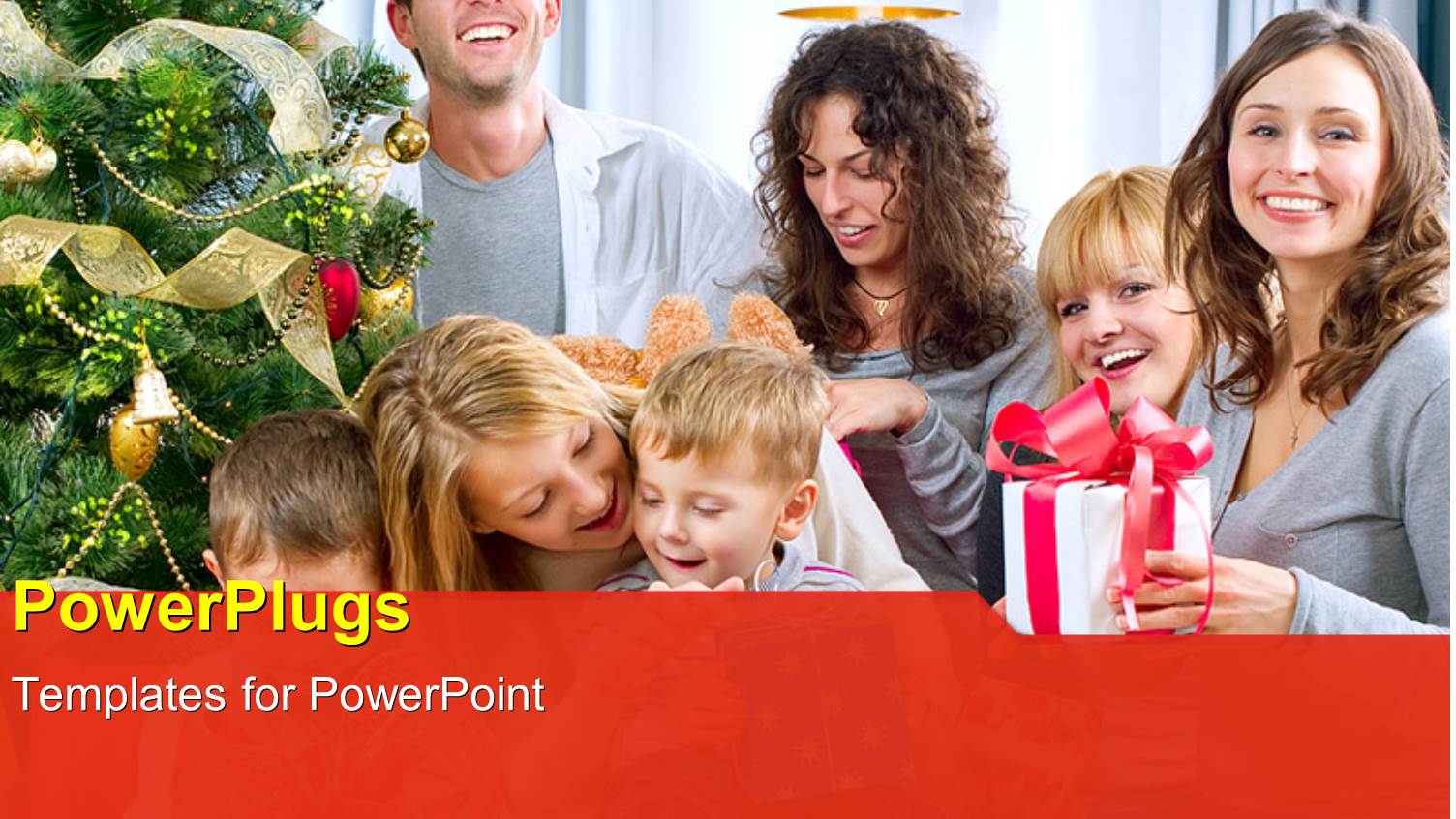 big Happy Family Celebrating at Christmas with Gift Box Beside Christmas Tree