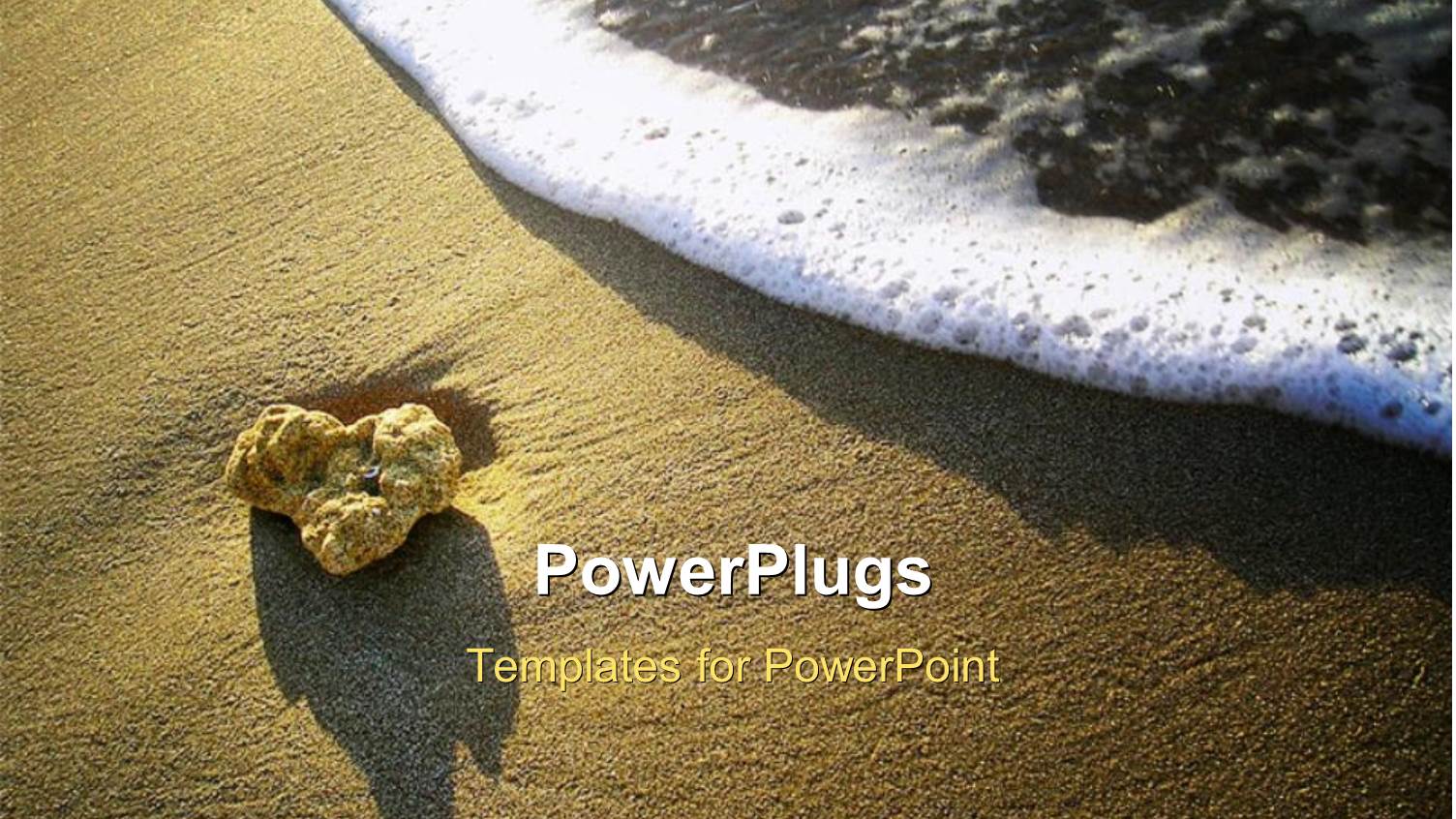 Foamy Ocean Wave Approaching Sandstone Pebble on Beach Sand