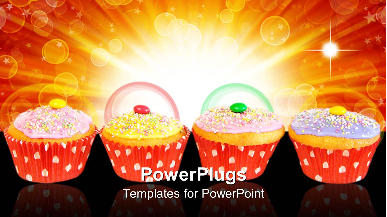 Four Muffins with Colorful Frosting and Candies in Red Paper