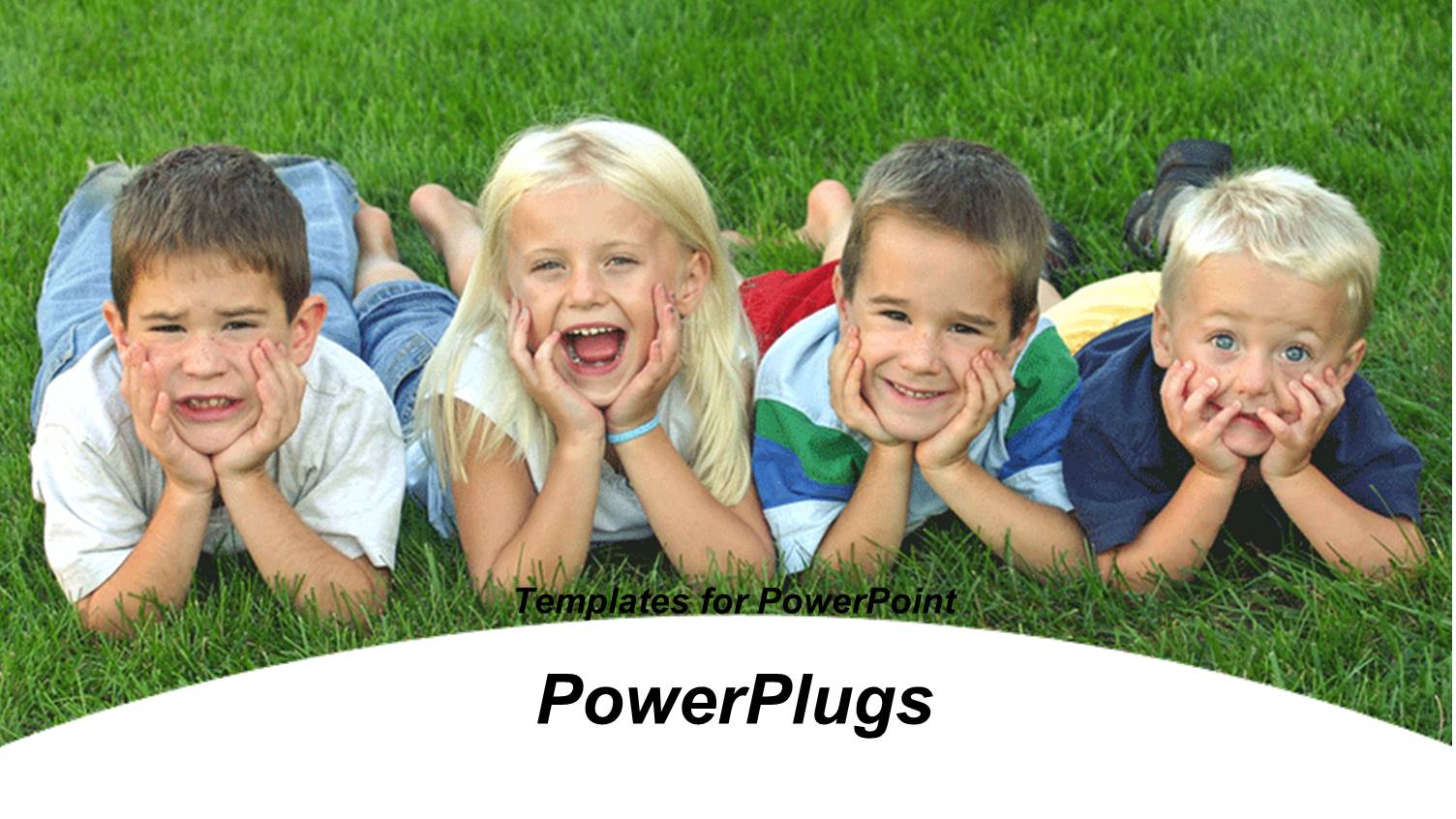 Four small Children Lying on Grassy Field Making Funny Faces