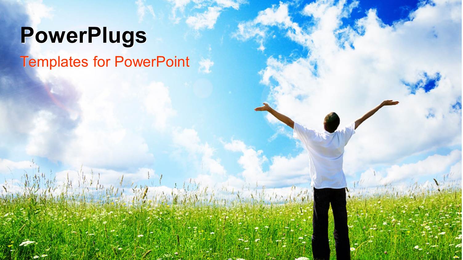 Happy Young Man with Hands Raised on Grass Field