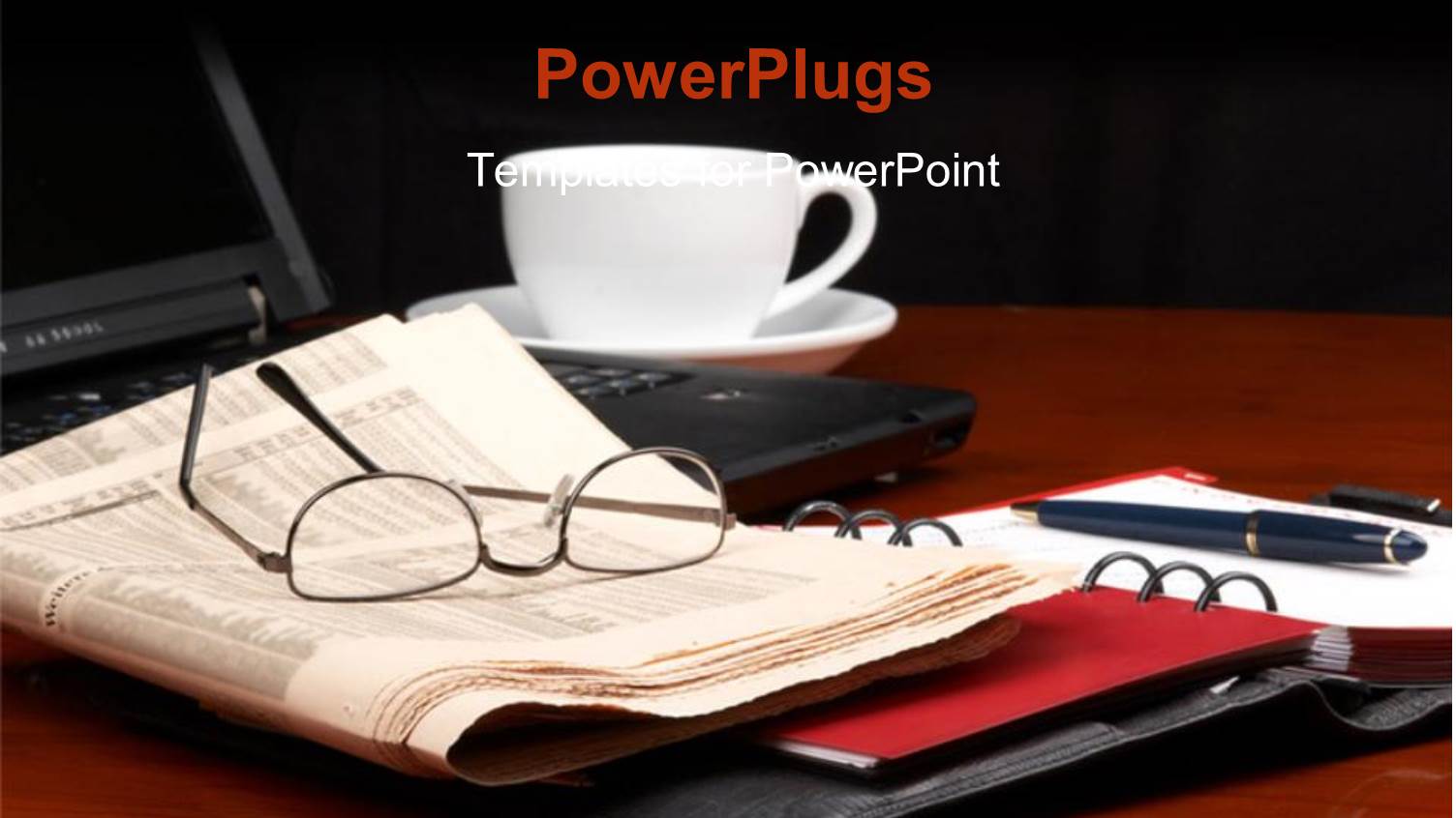 a Laptop with a Pair of Reading Glasses on a Newspaper