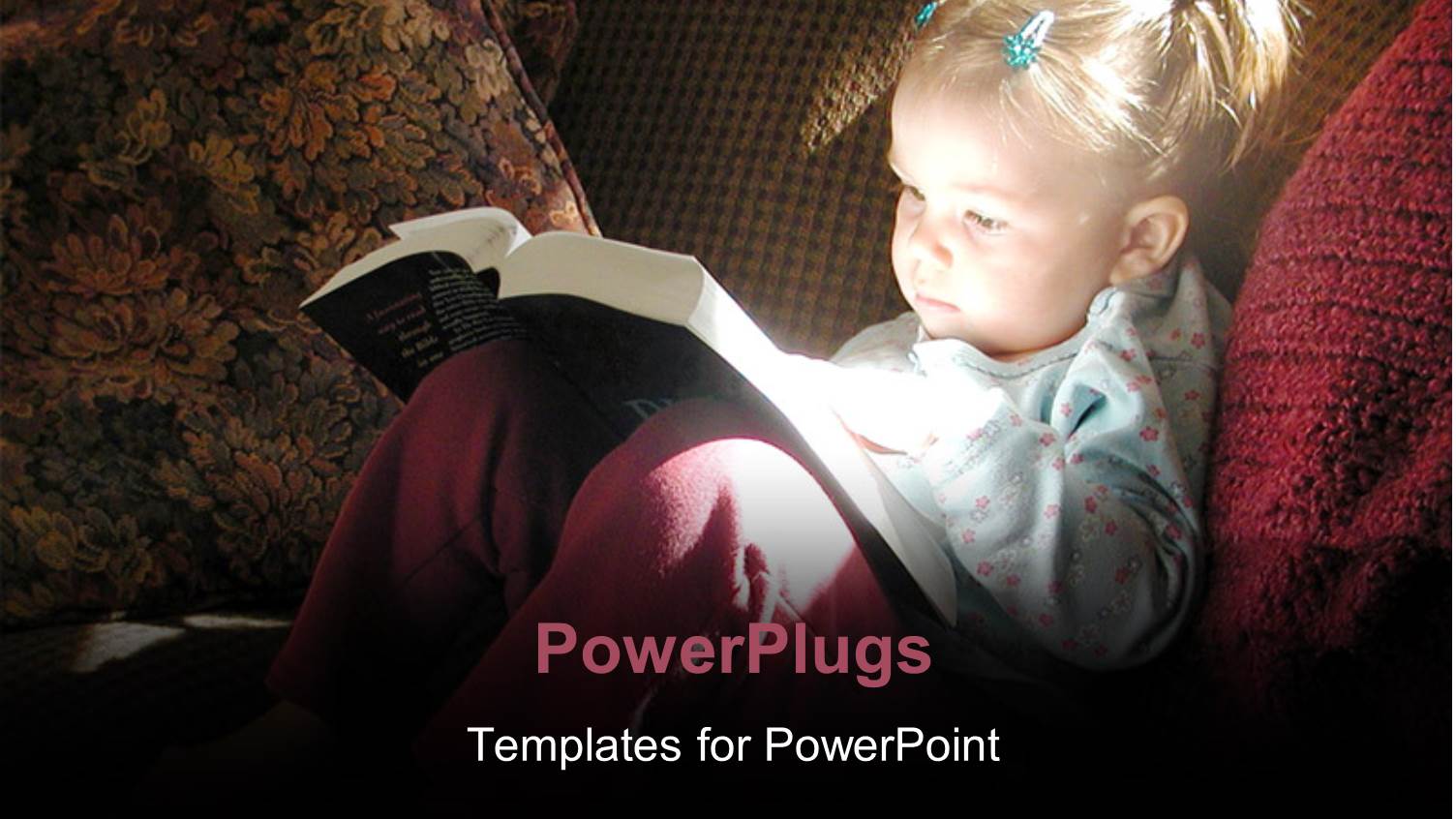 little Girl Reading Bible with Sunlight Reflecting off Book Back Onto her Face with Sofa