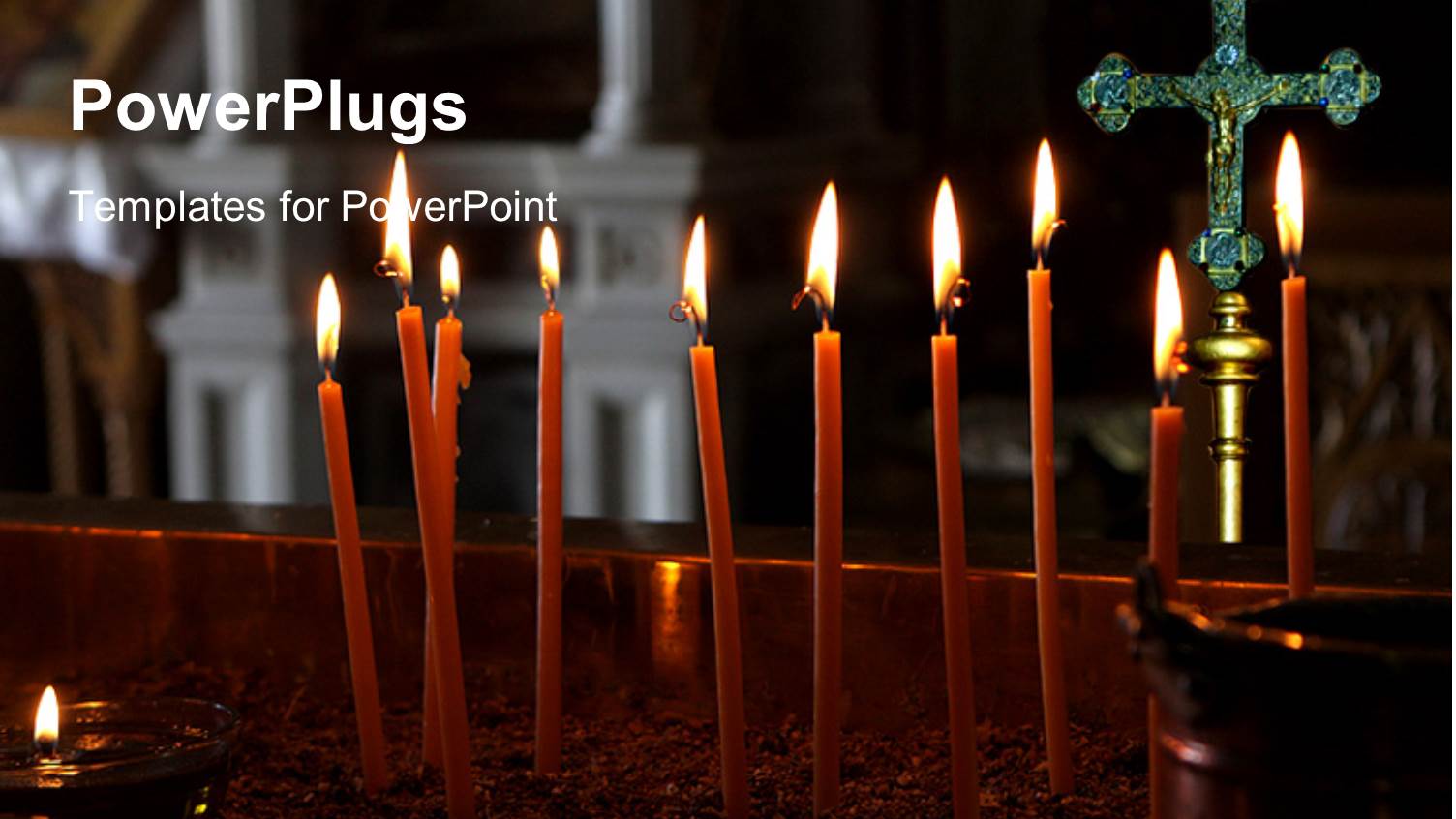 a Lot of Candles with a Cross in the Background