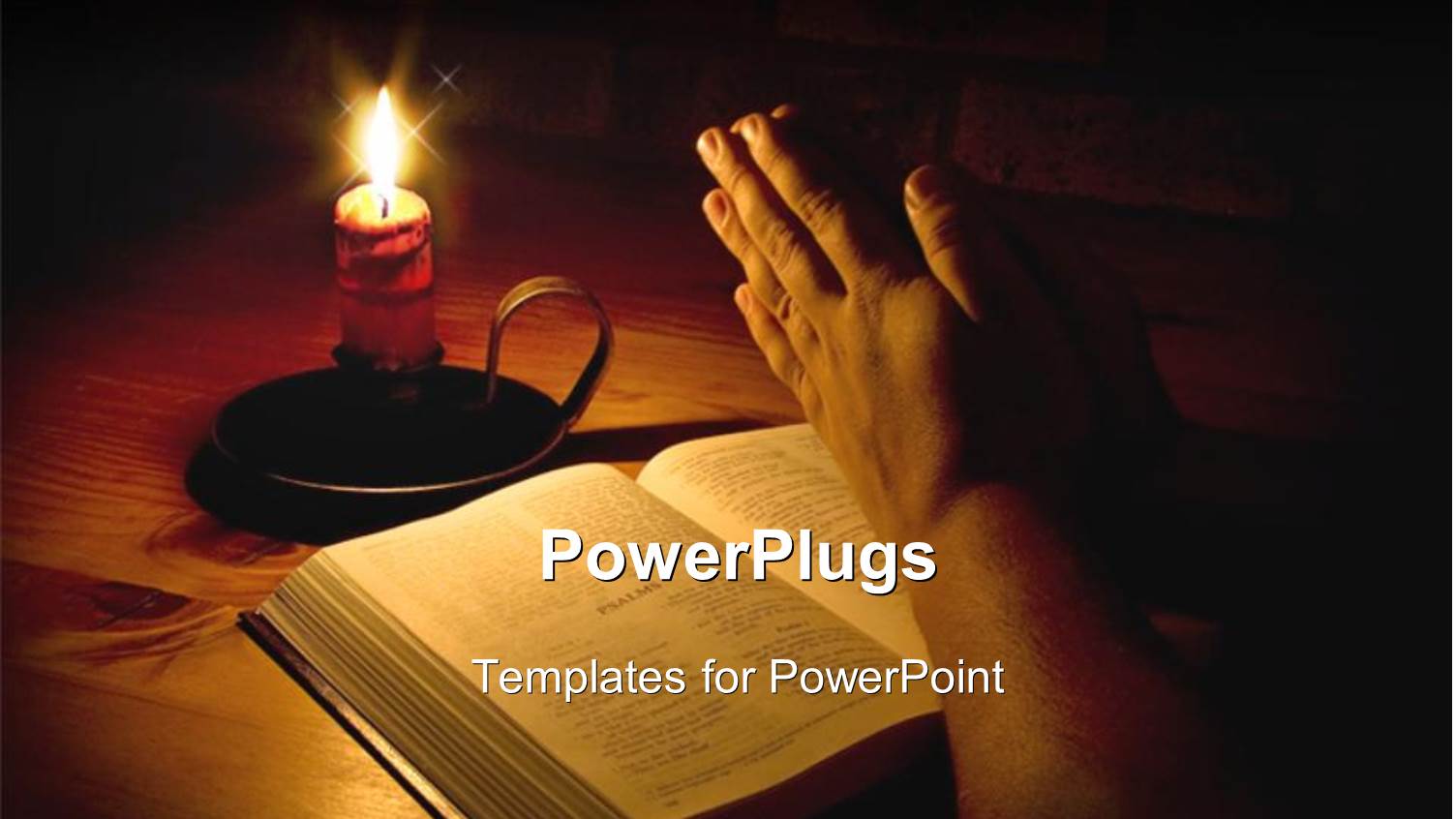 Man Praying Next to Bible with Candle