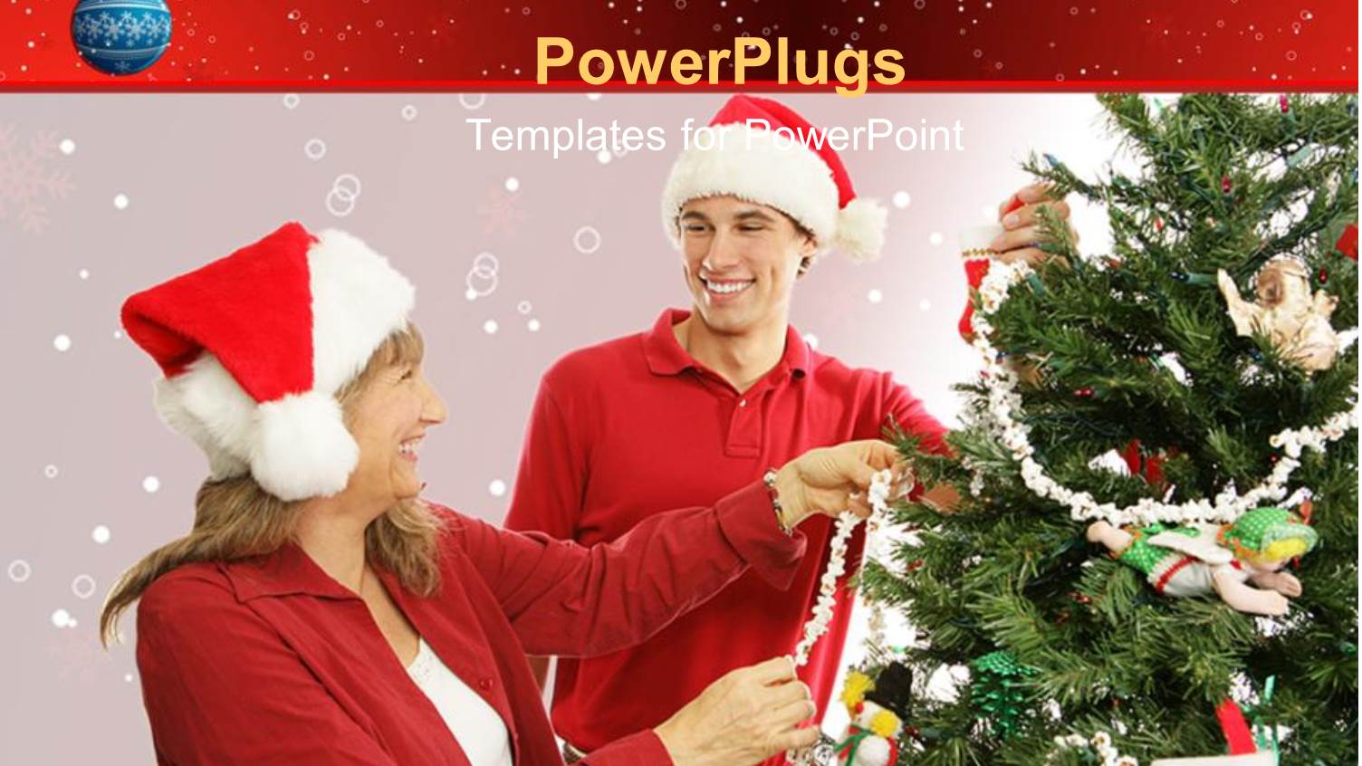 Mother and Son Wearing Santa Hats Decorate Christmas Tree