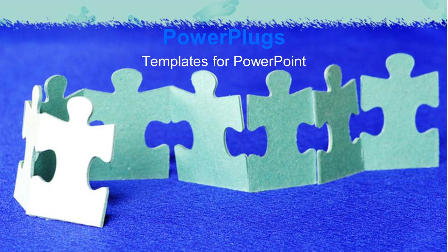 Paper Cut Puzzles Joined Together on a Rough Blue Surface