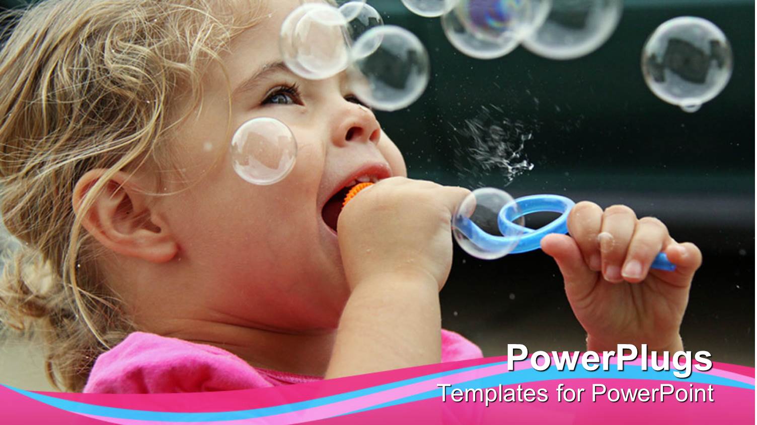 Pretty Baby Girl Blowing Out Bubbles and Smiling Outdoors