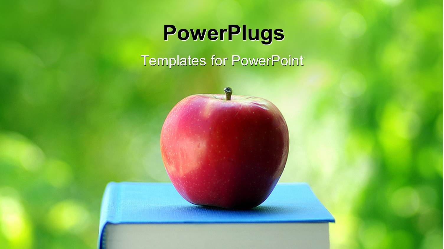 Red Apple on Blue Colored Book with Green Background 