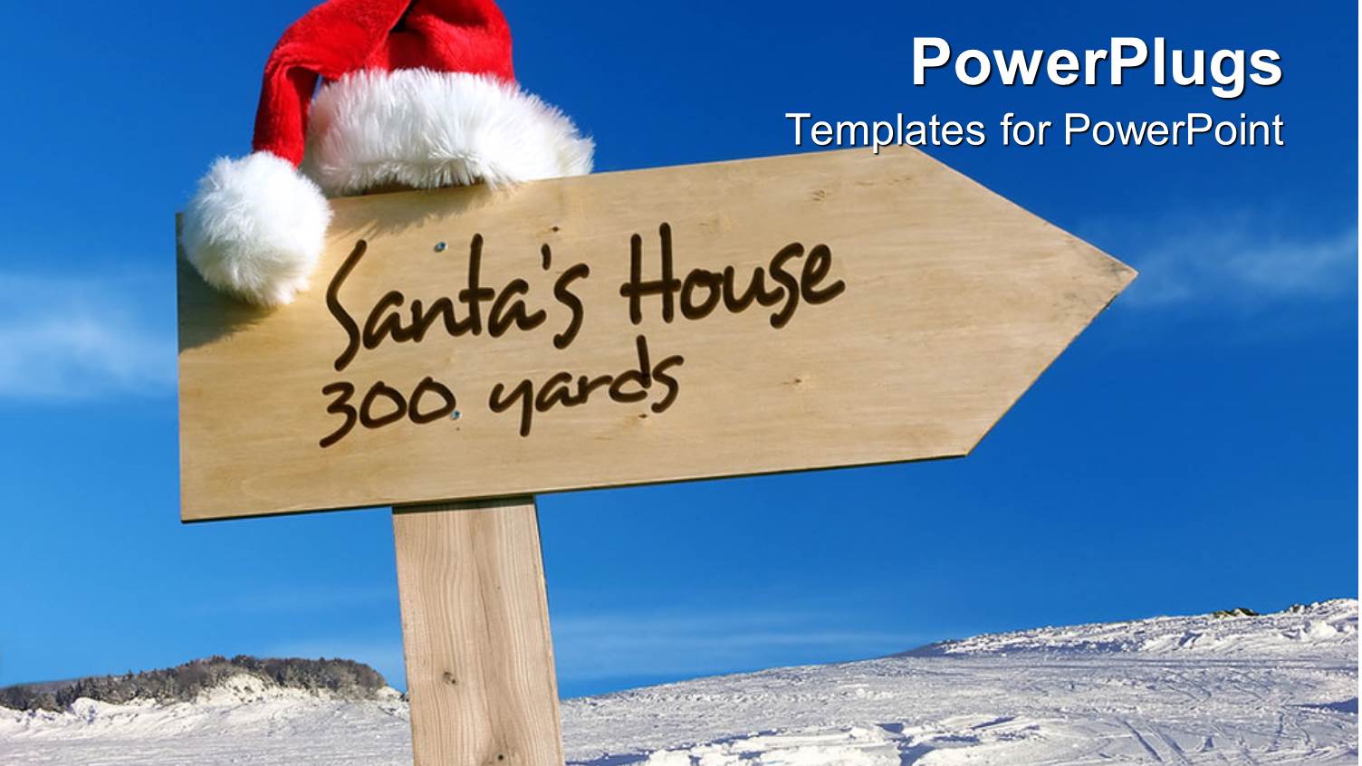 Sign Pointing Way to Santa's House with Snowy Background and Clear Blue Sky