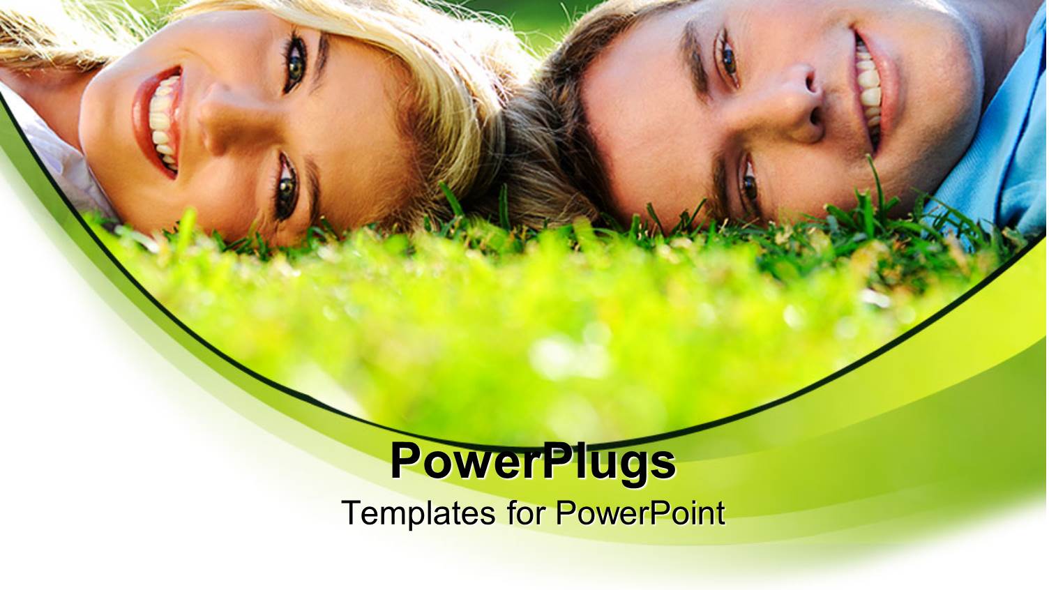 Smiling Young Man and Woman Lying in Green Grass with Heads Together