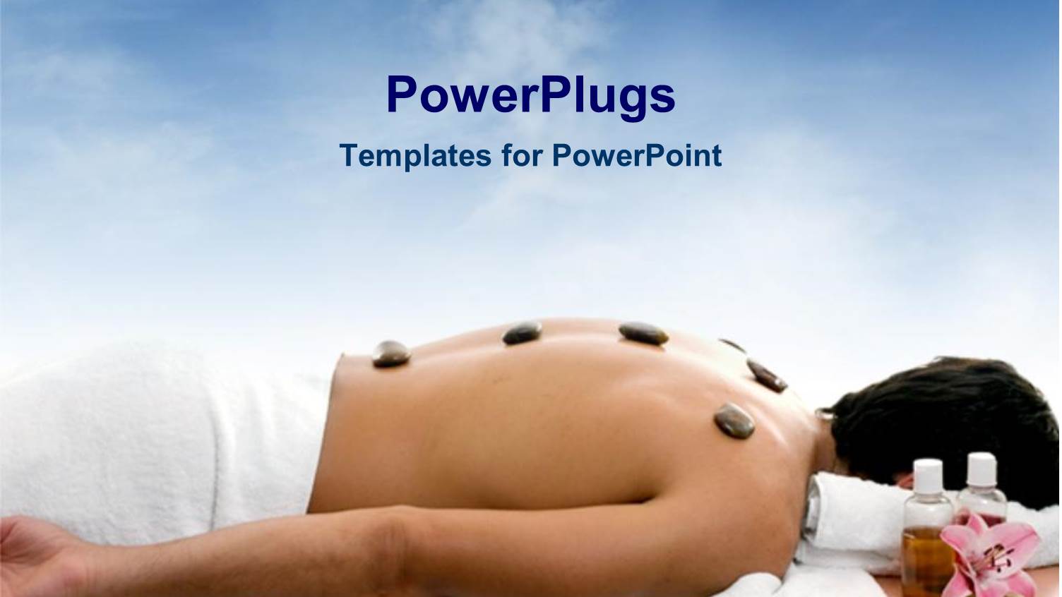 Spa Stones on Back of Man Lying on Massage Table