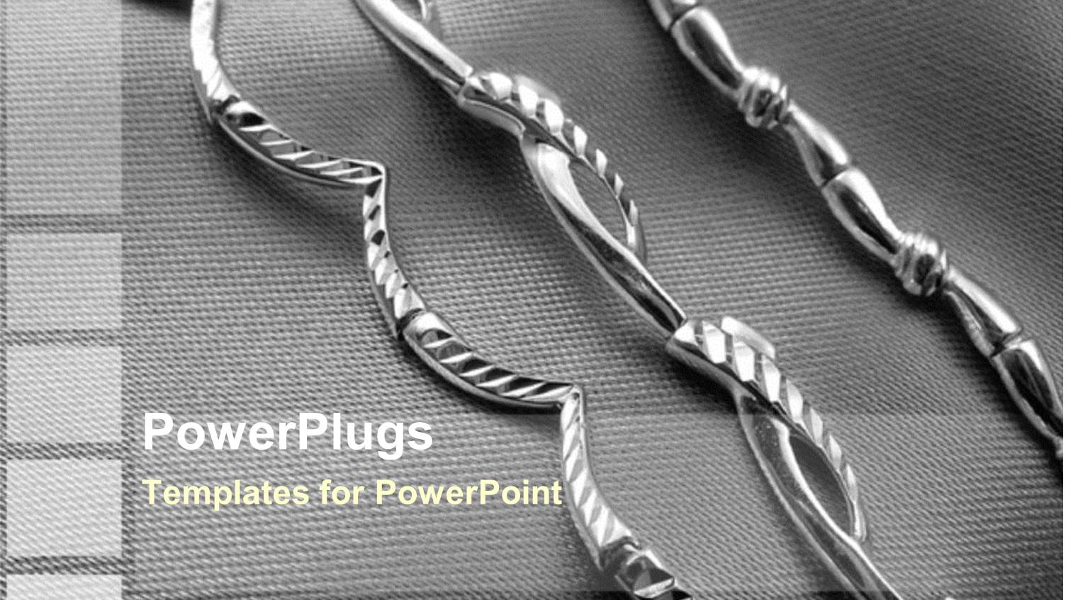 Three Decorated Silver Straight Chains on an Ash Colored Background