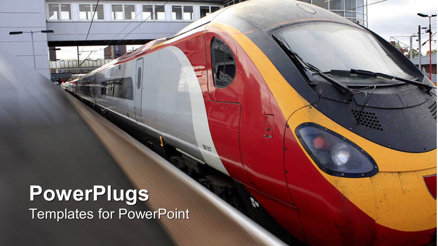 Train Going Through a Train Station with Building in the Background