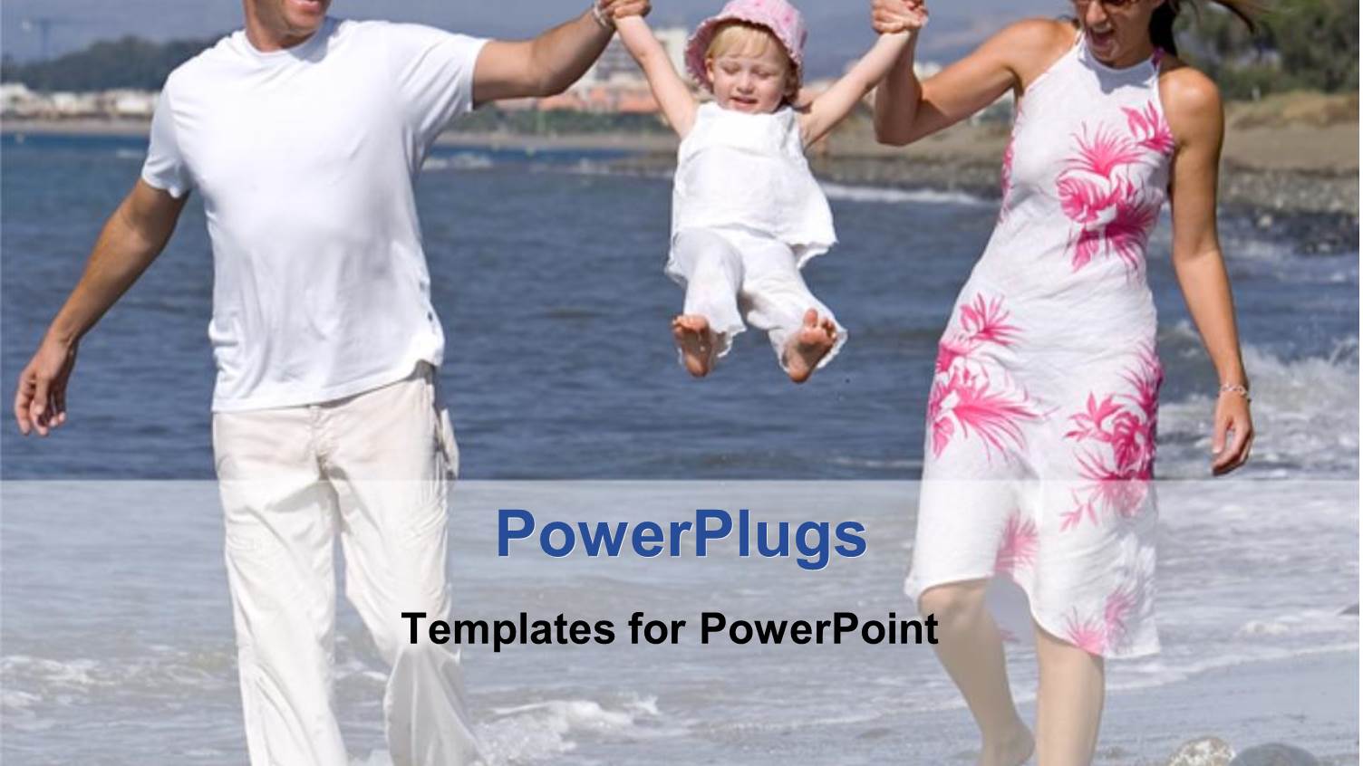 Two Adults and a Baby Walking on a Beach