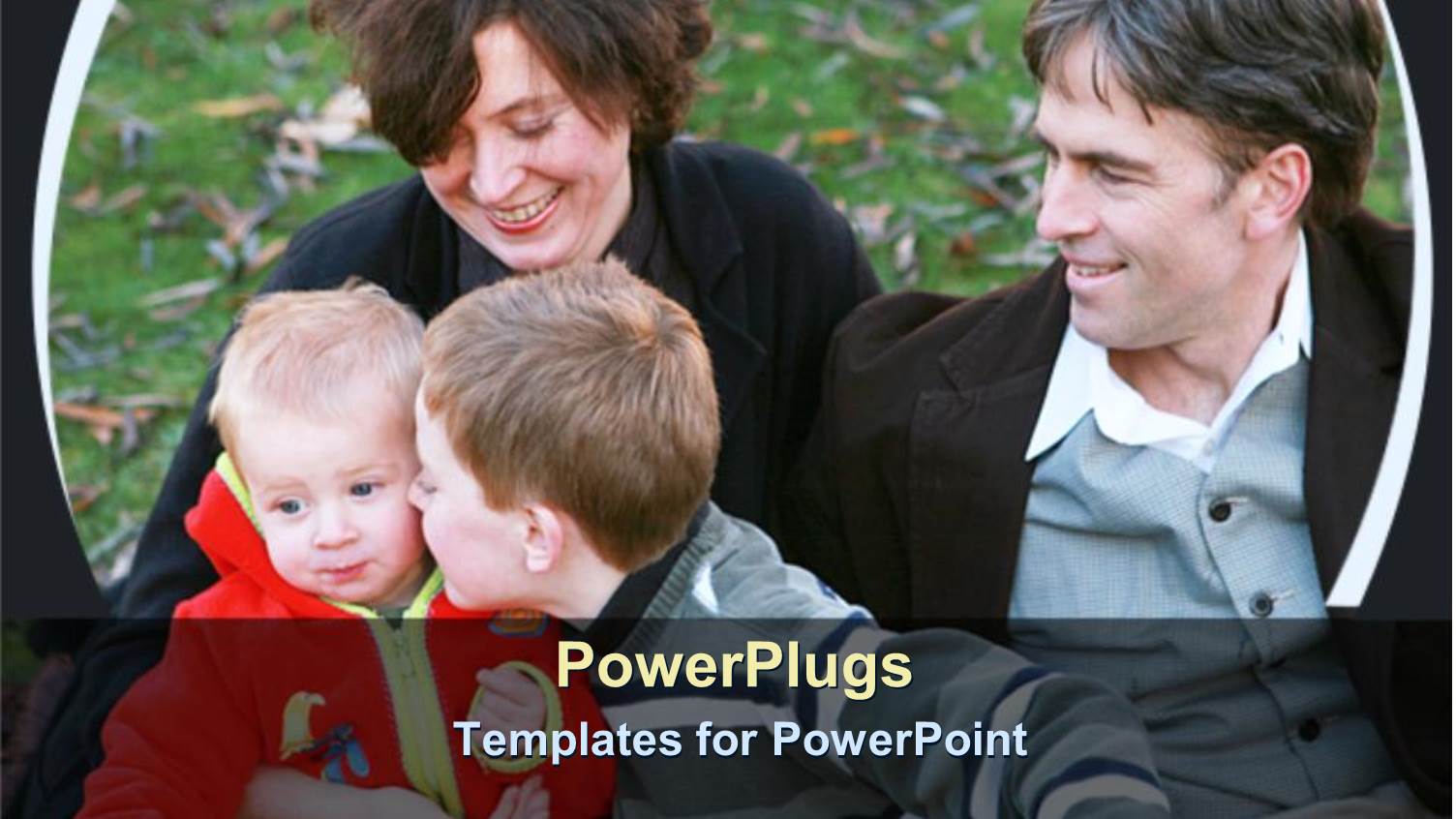 Two Adults with Two Kids Smiling and Kneeling on Grass