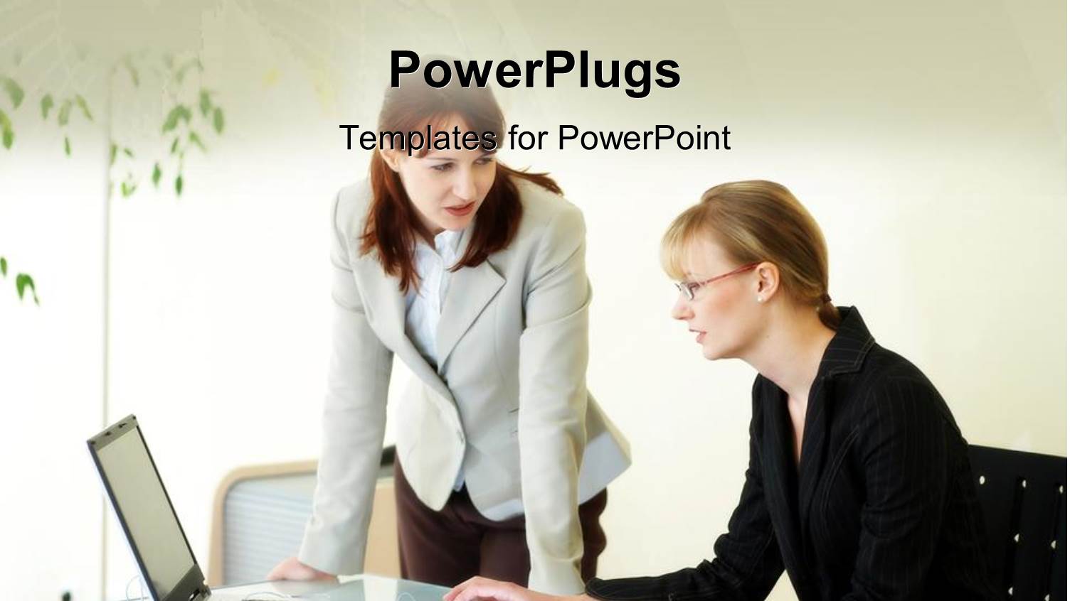 Two Females Having a Conversation while Looking at Laptop