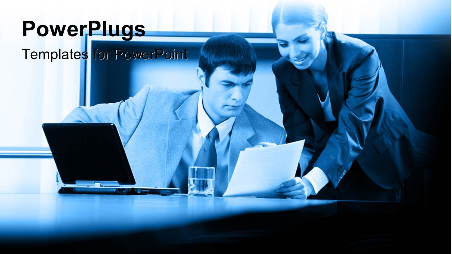 Two Professionals Discussing Over Document with Glass of Water and Laptop on Desk